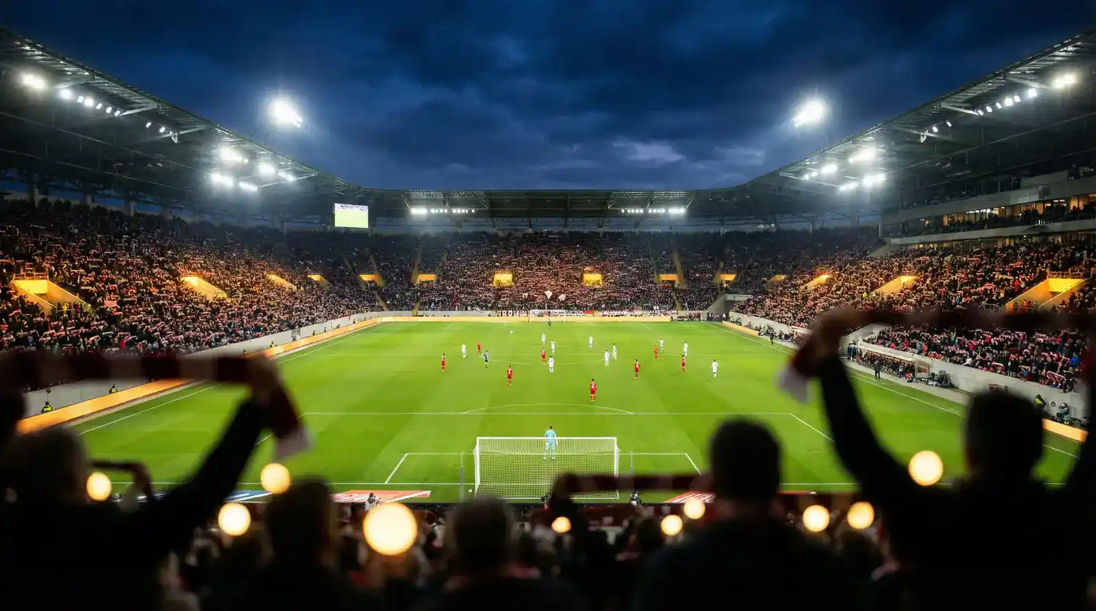 Estadio de la Bundesliga iluminado durante un partido nocturno con ambiente vibrante